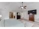 Large main bedroom with vaulted ceiling, ceiling fan, carpet, king bed, dresser and television at 206 Traditions Dr, Loganville, GA 30052