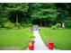 Lush backyard with a stone pathway leading to a charming bench surrounded by greenery and flower pots at 2407 Cove Lake Way, Lithonia, GA 30058