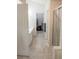 En-suite bathroom featuring dual sink, tiled floor, and a glass-enclosed shower with a walk in closet at 2407 Cove Lake Way, Lithonia, GA 30058