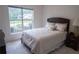 Bright bedroom features large window and neutral decor, creating a peaceful and inviting atmosphere at 2407 Cove Lake Way, Lithonia, GA 30058