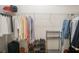 Well-organized walk-in closet with shelving and hanging rods filled with clothing and shoes at 2407 Cove Lake Way, Lithonia, GA 30058