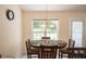 Dining area with a wooden table, chairs, and a view of the well landscaped backyard at 2407 Cove Lake Way, Lithonia, GA 30058