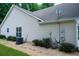Home exterior featuring neutral siding, gravel landscaping, and visible utilities and external AC unit at 2407 Cove Lake Way, Lithonia, GA 30058