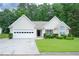 Charming single-story home with well-maintained lawn and two car garage and manicured shrubs at 2407 Cove Lake Way, Lithonia, GA 30058