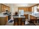 Well-lit kitchen with white appliances, wood cabinets, and a cozy eat-in breakfast area at 2407 Cove Lake Way, Lithonia, GA 30058