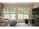Bright sun room with neutral colored decor and great views of the green back yard at 2407 Cove Lake Way, Lithonia, GA 30058