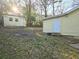 Spacious backyard with a shed or outbuilding and a partially wooded area at 3254 Howell Cir, Duluth, GA 30096