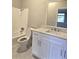 Bathroom with white cabinets, marble countertop and backsplash and white tile floor and shower at 3254 Howell Cir, Duluth, GA 30096