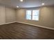 Bedroom featuring updated flooring, neutral paint, and natural light at 3254 Howell Cir, Duluth, GA 30096