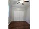 Bedroom featuring hardwood floors, neutral paint, and a double door sliding closet at 3254 Howell Cir, Duluth, GA 30096