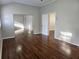 Bedroom featuring hardwood floors, a sliding door mirrored closet, and white painted walls at 3254 Howell Cir, Duluth, GA 30096