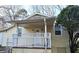 Quaint home features a covered front porch and a manicured yard with mature trees at 3254 Howell Cir, Duluth, GA 30096