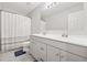 Bathroom with double sink vanity and shower with curtain at 3569 Tupelo Trl, Auburn, GA 30011