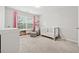 Serene Bedroom featuring a crib, rocking chair, and plenty of storage at 3569 Tupelo Trl, Auburn, GA 30011