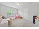 Playful bedroom with carpet floors, a window, and plenty of room for activities at 3569 Tupelo Trl, Auburn, GA 30011