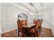 Dining room with modern chandelier, hardwood floors, and white trim at 3569 Tupelo Trl, Auburn, GA 30011