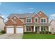 Beautiful two-story brick home with attached two-car garage and manicured lawn at 3569 Tupelo Trl, Auburn, GA 30011