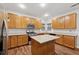 Bright kitchen with wood cabinets, stainless appliances, granite counters and island at 3569 Tupelo Trl, Auburn, GA 30011