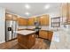 Open kitchen boasts stainless appliances, granite countertops, and wooden island at 3569 Tupelo Trl, Auburn, GA 30011