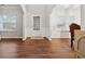 Living room with hardwood floors, white wainscoting, and arched doorways at 3569 Tupelo Trl, Auburn, GA 30011