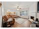 Inviting living room featuring a fireplace, hardwood floors, and open access to the kitchen at 3569 Tupelo Trl, Auburn, GA 30011