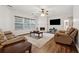 Comfortable living room with hardwood floors, fireplace, and plush leather seating at 3569 Tupelo Trl, Auburn, GA 30011