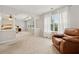 Spacious main bedroom featuring a tray ceiling, plush carpet, sitting area, and plenty of natural light at 3569 Tupelo Trl, Auburn, GA 30011