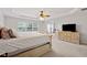Large main bedroom with a tray ceiling, natural light, and a view of the sitting area at 3569 Tupelo Trl, Auburn, GA 30011