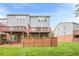 Back view of townhomes with yard and wooden decks at 5589 Trace Views Dr, Norcross, GA 30071