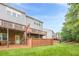 Well-maintained backyard featuring a wooden fence, second story balconies, and a lush lawn, perfect for outdoor activities at 5589 Trace Views Dr, Norcross, GA 30071