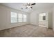 Bedroom with neutral carpet, ensuite bathroom, and natural light from windows at 5589 Trace Views Dr, Norcross, GA 30071