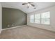 Bedroom featuring vaulted ceilings, neutral carpet, and three bright windows at 5589 Trace Views Dr, Norcross, GA 30071