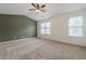 Bedroom featuring vaulted ceilings, neutral carpet, and natural light from two windows at 5589 Trace Views Dr, Norcross, GA 30071
