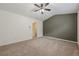 Bedroom with vaulted ceilings, neutral carpet, and a painted accent wall at 5589 Trace Views Dr, Norcross, GA 30071