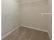 Carpeted walk-in closet with adjustable shelving and ample storage at 5589 Trace Views Dr, Norcross, GA 30071