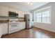 Bright kitchen featuring stainless steel appliances, granite countertops, and wood-look flooring at 5589 Trace Views Dr, Norcross, GA 30071