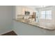 Kitchen with granite countertops, white cabinets, stainless steel appliances, and breakfast bar at 5589 Trace Views Dr, Norcross, GA 30071