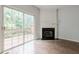 Living room with fireplace, sliding glass doors to deck and views of trees at 5589 Trace Views Dr, Norcross, GA 30071