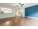 Bright living room with open floor plan, ceiling fan, and a view into the kitchen area at 5589 Trace Views Dr, Norcross, GA 30071