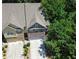 An aerial view of a home showcasing the driveway and mature trees in the surrounding community at 1547 Paxton Sw Dr, Lilburn, GA 30047