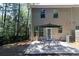 Inviting backyard patio with dining set, perfect for outdoor relaxation and entertaining, surrounded by lush greenery at 1547 Paxton Sw Dr, Lilburn, GA 30047