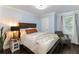 Bedroom featuring a comfortable chair, light blue walls, and hardwood floors at 1547 Paxton Sw Dr, Lilburn, GA 30047