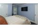 Bedroom featuring a TV, light blue walls, and hardwood floors at 1547 Paxton Sw Dr, Lilburn, GA 30047