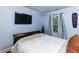 Bedroom featuring a mounted tv, light blue walls, and hardwood floors at 1547 Paxton Sw Dr, Lilburn, GA 30047