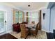 A view of the modern dining room with plenty of natural light from the surrounding windows at 1547 Paxton Sw Dr, Lilburn, GA 30047
