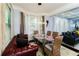 Open-concept dining room with a glass table, a leather sofa, and modern decor at 1547 Paxton Sw Dr, Lilburn, GA 30047