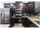 Modern kitchen featuring stainless steel appliances, granite countertops, and dark cabinets at 1547 Paxton Sw Dr, Lilburn, GA 30047