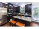 Modern kitchen with dark cabinets, stainless appliances, granite countertops, and a butcher block island at 1547 Paxton Sw Dr, Lilburn, GA 30047