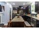 A modern kitchen features dark cabinetry, stainless steel appliances, and granite countertops at 1547 Paxton Sw Dr, Lilburn, GA 30047