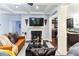 A view of the open living room featuring a fireplace, modern decor, and sleek finishes at 1547 Paxton Sw Dr, Lilburn, GA 30047